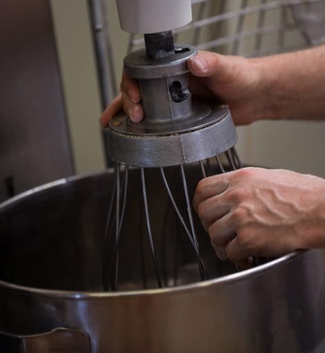 Close-up of hand adjusting dough machine